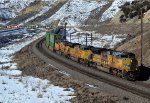 UP 8664, 9021, 7781 (SD70ACE, SD70ACE, C45ACCTE) lead an eastbound stack train approaching the Echo Rd. OHB in Emory, Utah. February 19, 2022 {Winter Echofest}